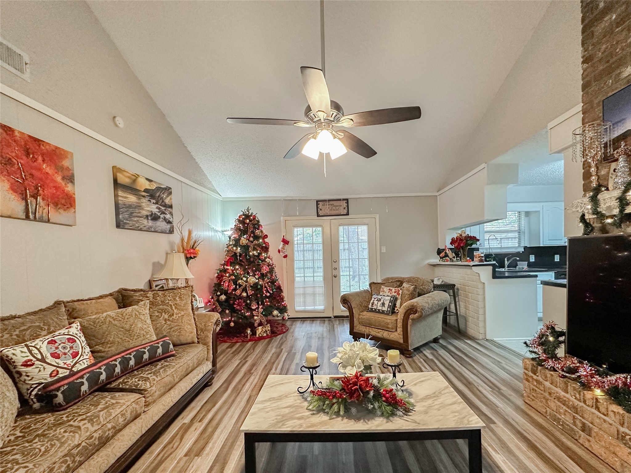 a living room with furniture and kitchen view