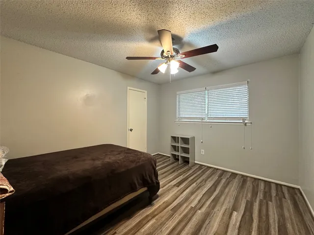 a bedroom with a bed and a ceiling fan