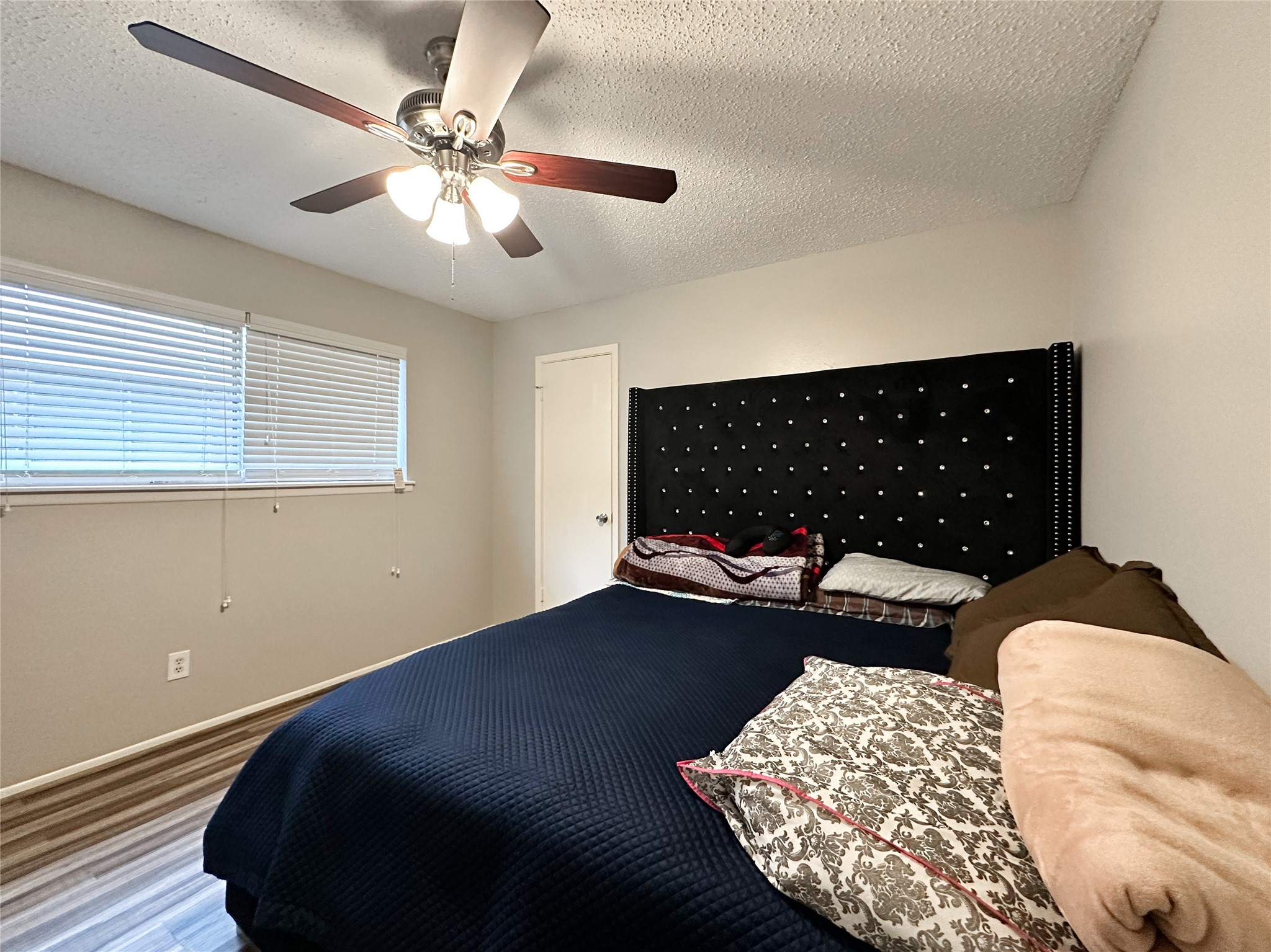 22319 Meadowgate Drive Spring, TX 77373 - Photo 13 of 19 a bed sitting in a bedroom next to a window and a chandelier