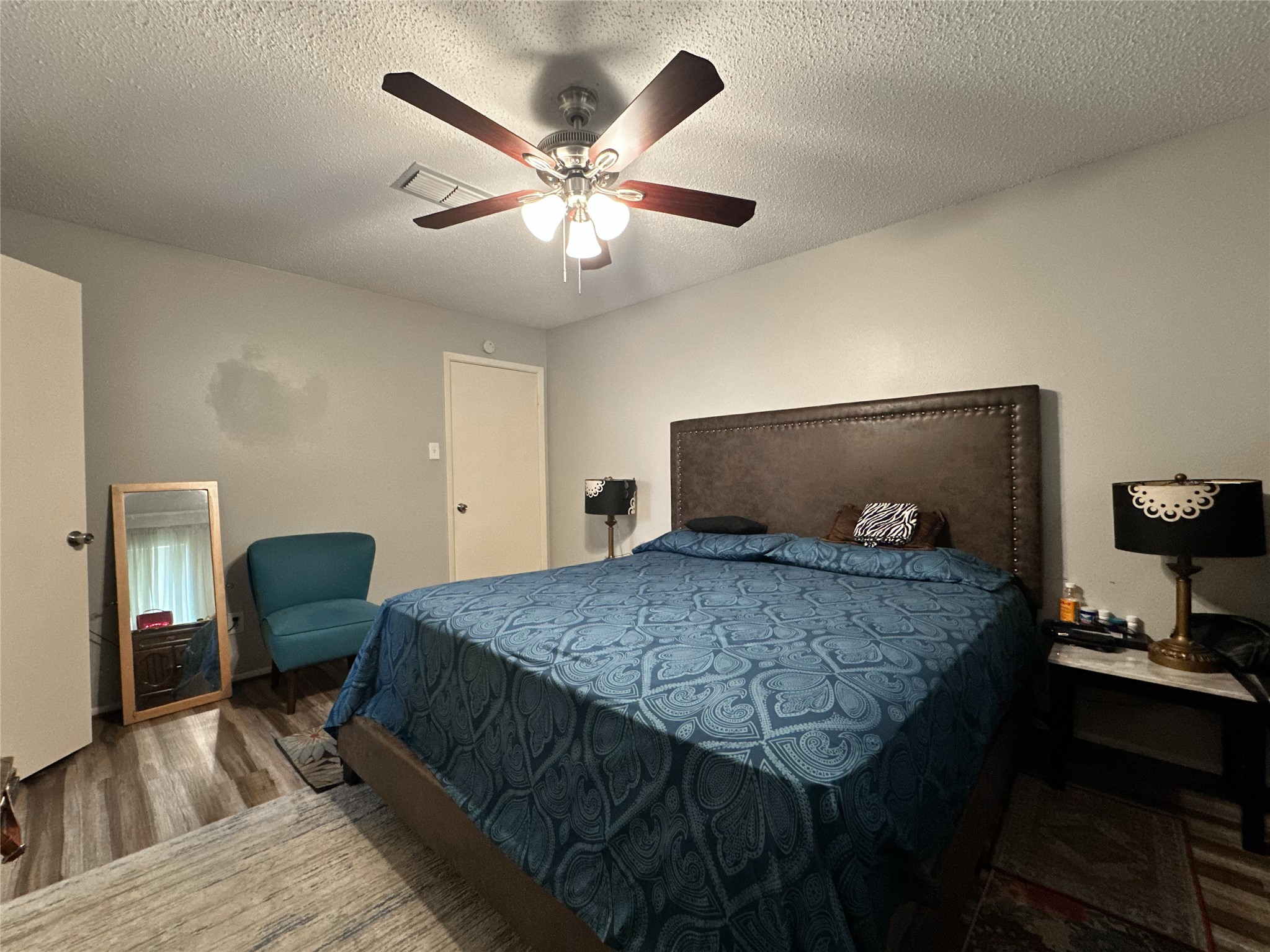22319 Meadowgate Drive Spring, TX 77373 - Photo 14 of 19 a bedroom with a bed and a chandelier