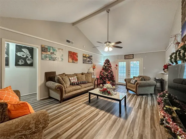 a living room with furniture and a chandelier