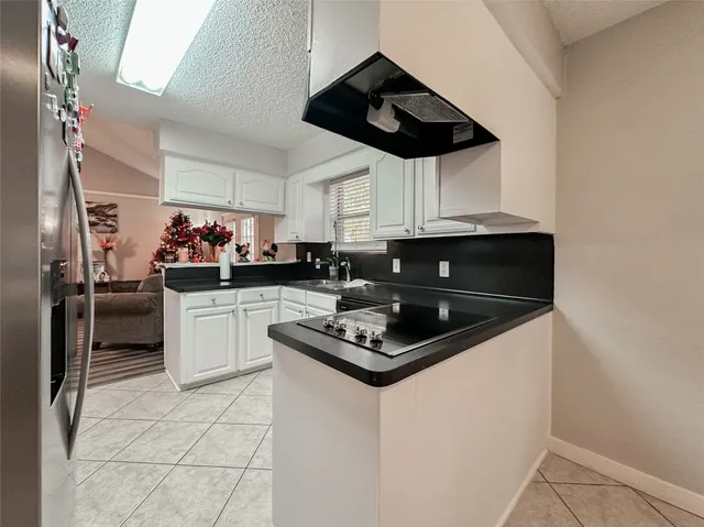 a kitchen with stainless steel appliances a sink a stove and cabinets