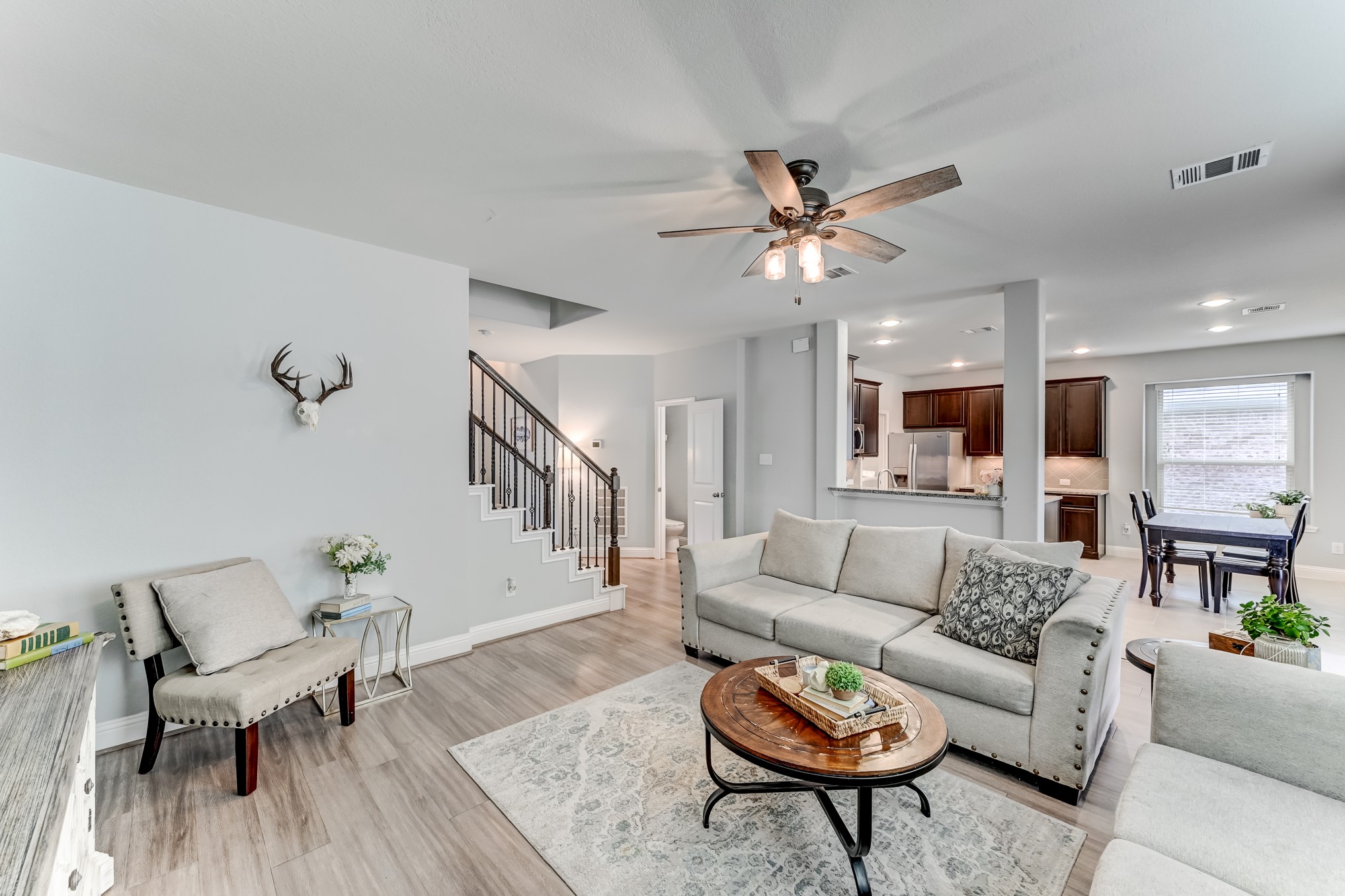 23831 Pennington Hills Drive Spring, TX 77389 - Photo 11 of 46 a living room with furniture a rug and a chandelier