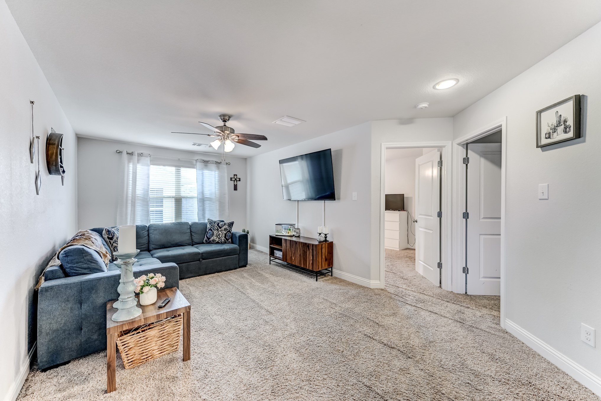 23831 Pennington Hills Drive Spring, TX 77389 - Photo 22 of 46 a living room with furniture and a flat screen tv