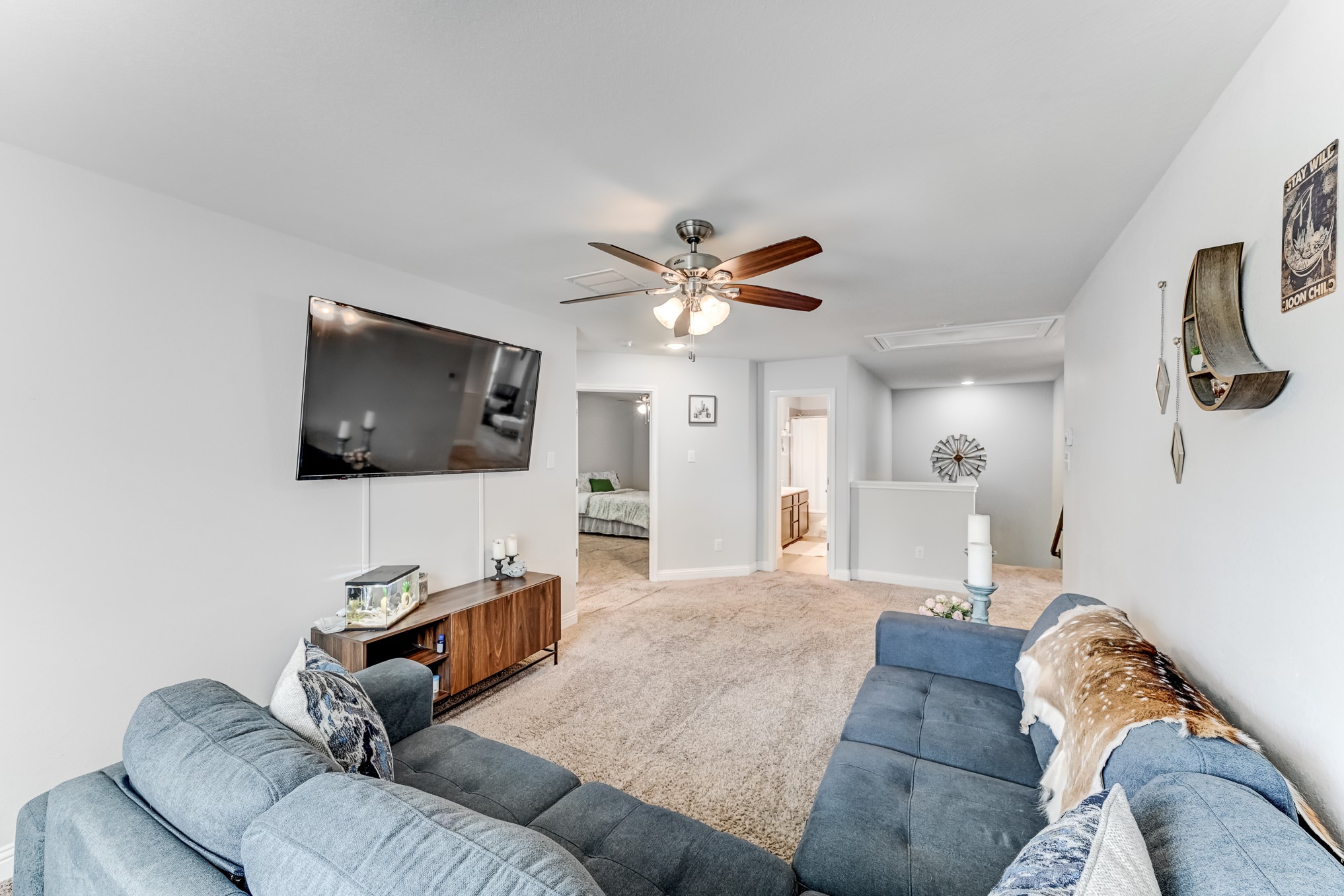23831 Pennington Hills Drive Spring, TX 77389 - Photo 24 of 46 a living room with furniture and a flat screen tv