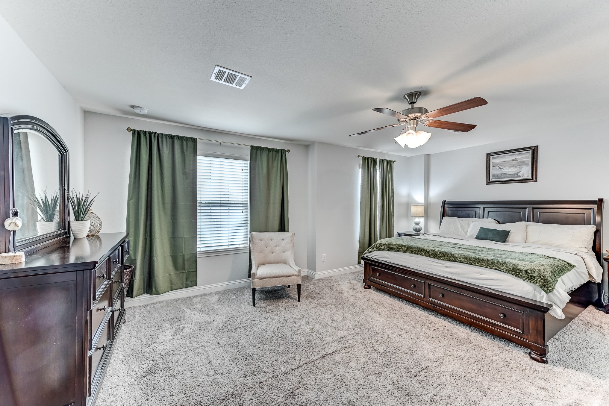 23831 Pennington Hills Drive Spring, TX 77389 - Photo 25 of 46 a spacious bedroom with a bed and a chandelier