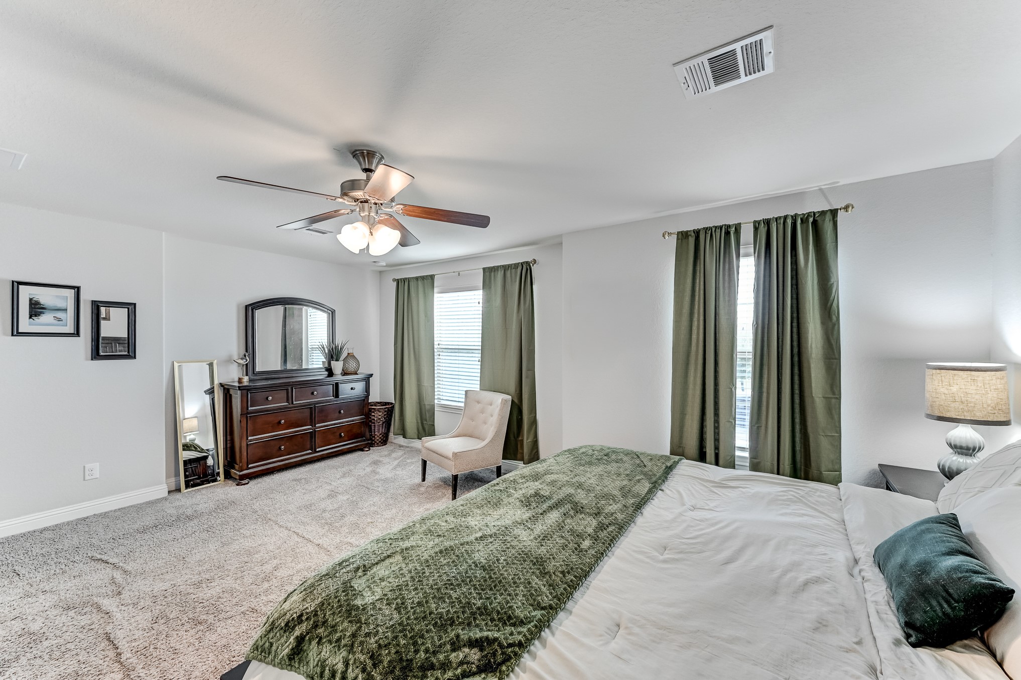 23831 Pennington Hills Drive Spring, TX 77389 - Photo 26 of 46 a bedroom with a bed dresser and a chandelier