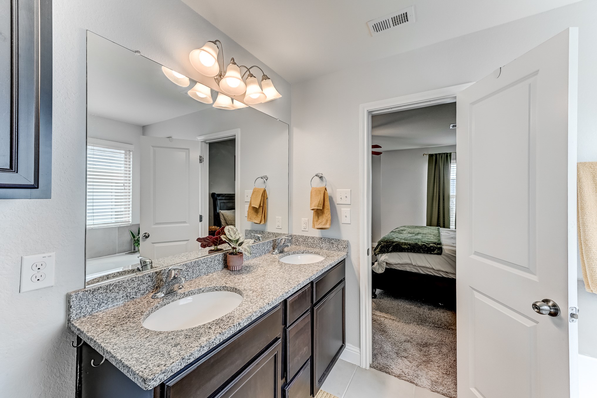 23831 Pennington Hills Drive Spring, TX 77389 - Photo 28 of 46 a en suite bathroom with a granite countertop sink and a mirror