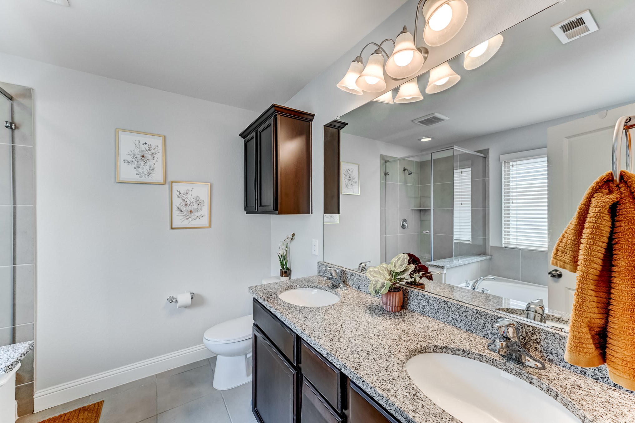 23831 Pennington Hills Drive Spring, TX 77389 - Photo 29 of 46 a bathroom with a granite countertop double vanity sink and a mirror