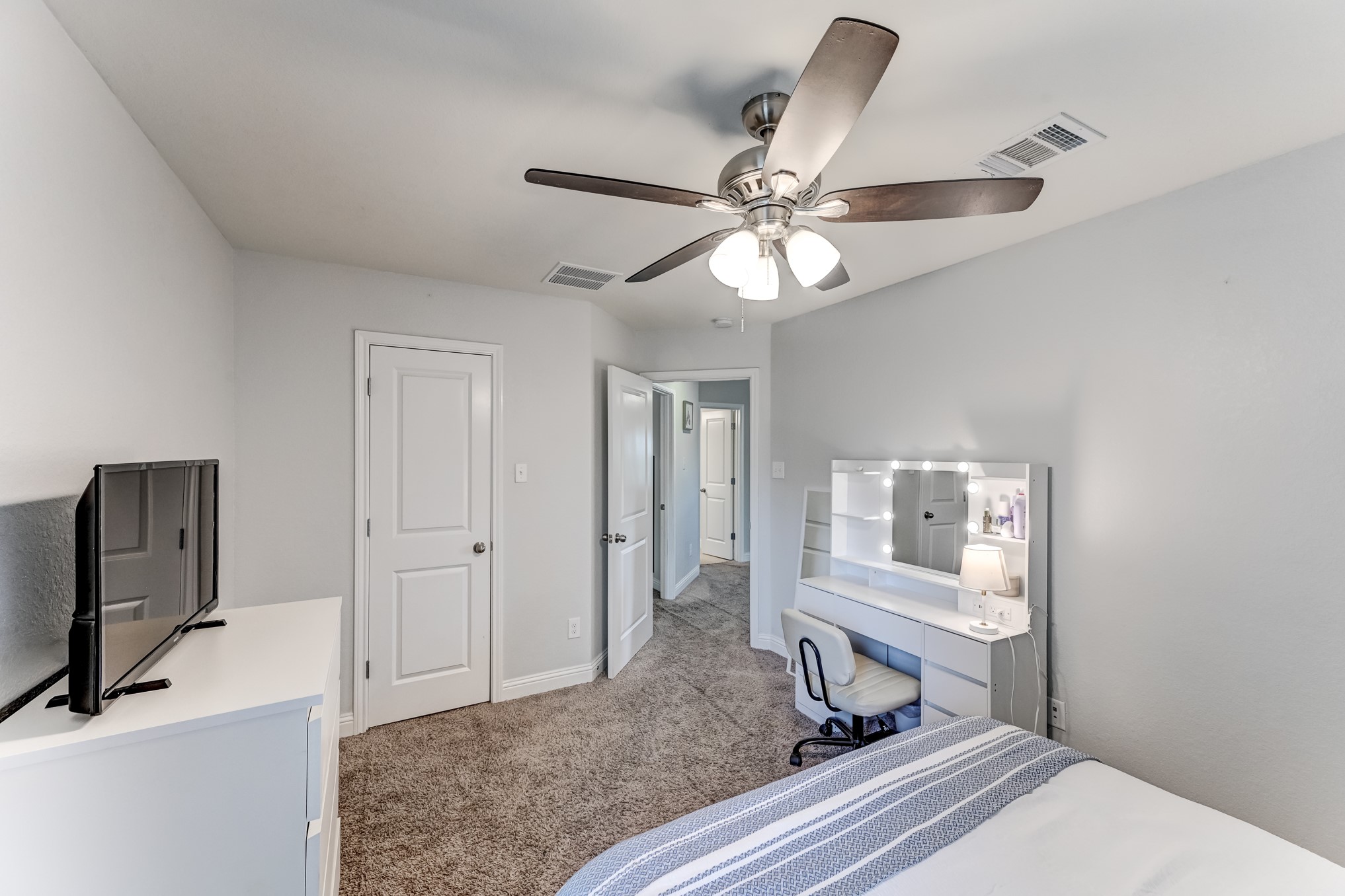 23831 Pennington Hills Drive Spring, TX 77389 - Photo 35 of 46 a bedroom with a bed and a chandelier