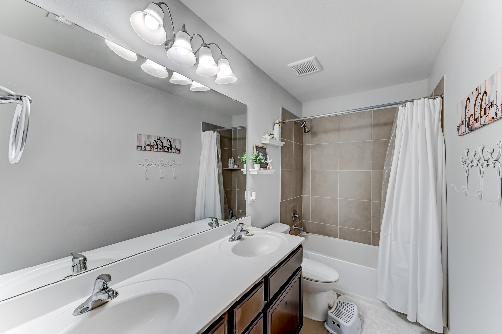 23831 Pennington Hills Drive Spring, TX 77389 - Photo 36 of 46 a bathroom with a sink vanity mirror and toilet
