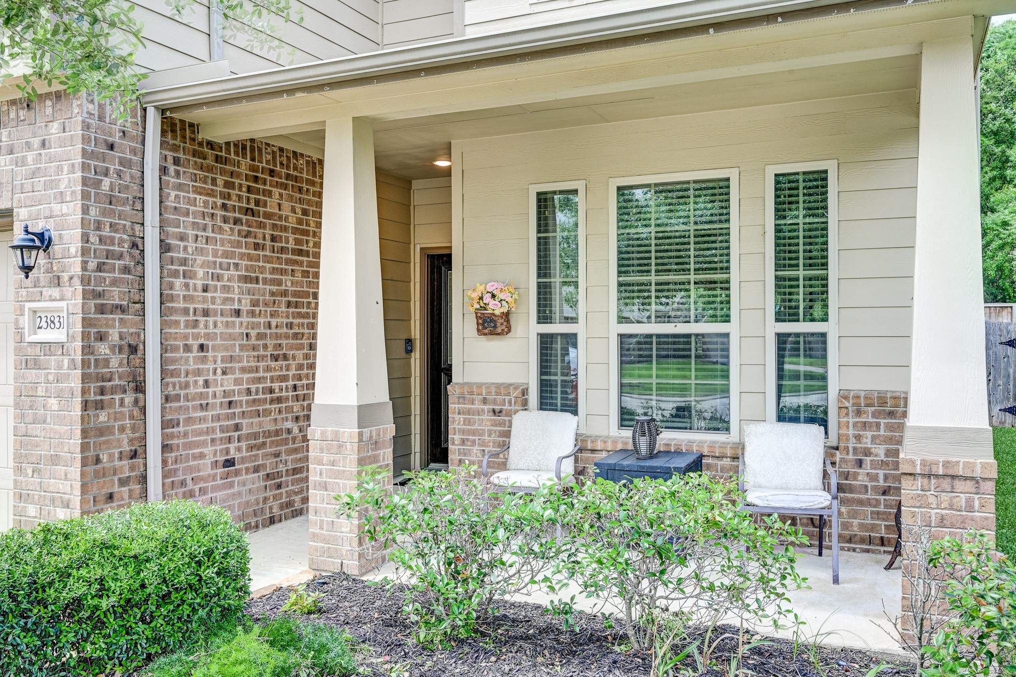 23831 Pennington Hills Drive Spring, TX 77389 - Photo 4 of 46 a front view of a house with a large window and table and chairs