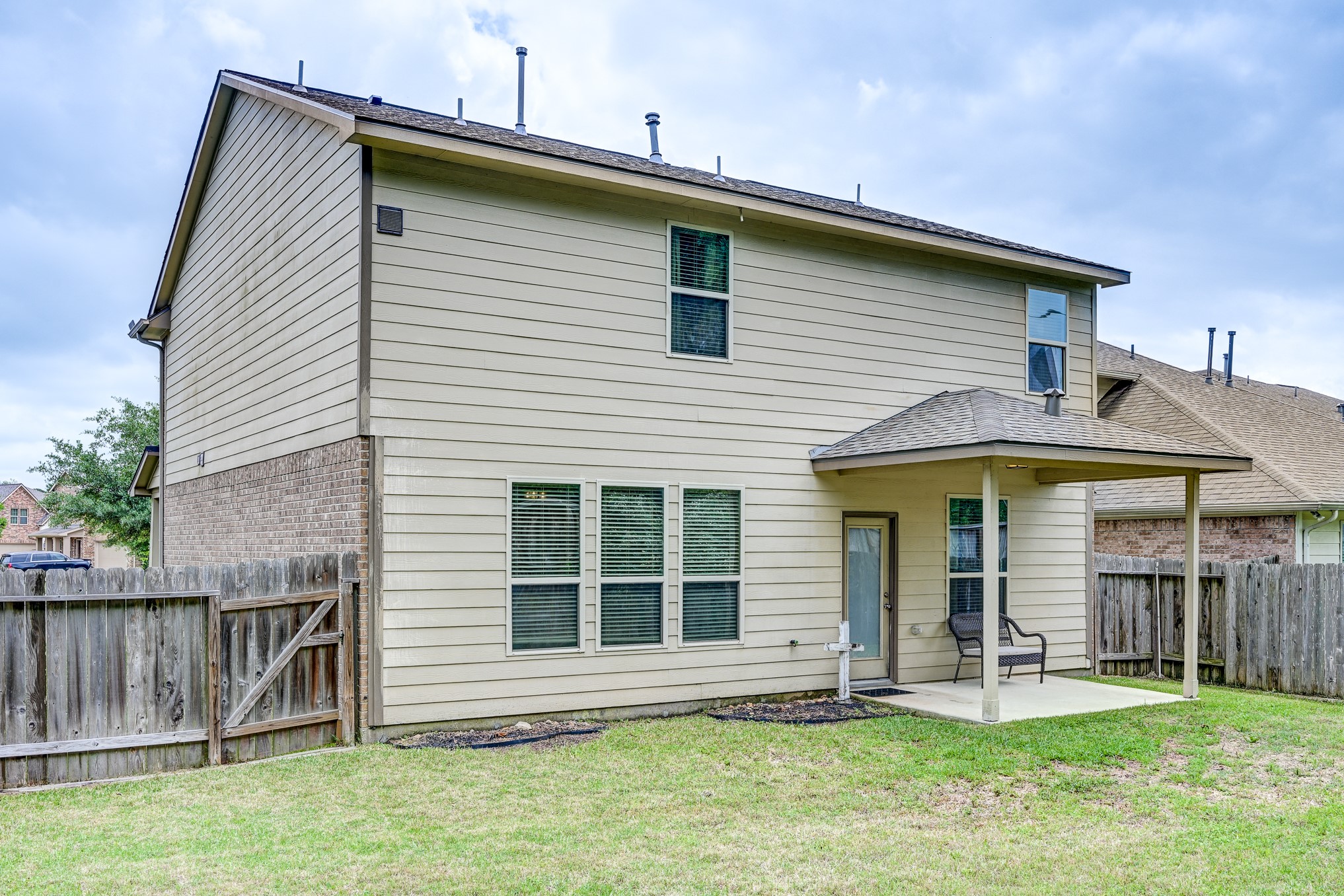23831 Pennington Hills Drive Spring, TX 77389 - Photo 44 of 46 a front view of a house with a yard and porch