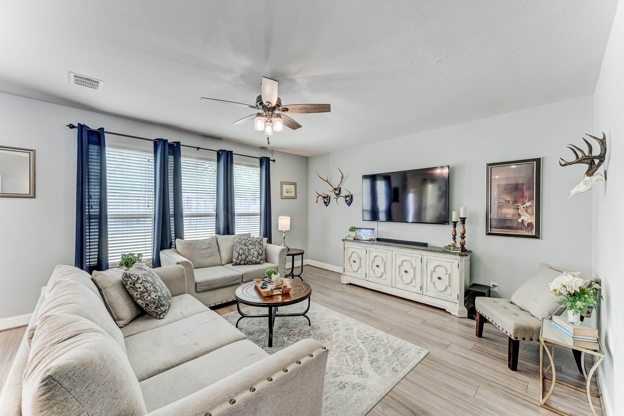 23831 Pennington Hills Drive Spring, TX 77389 - Photo 10 of 46 a living room with furniture and a flat screen tv