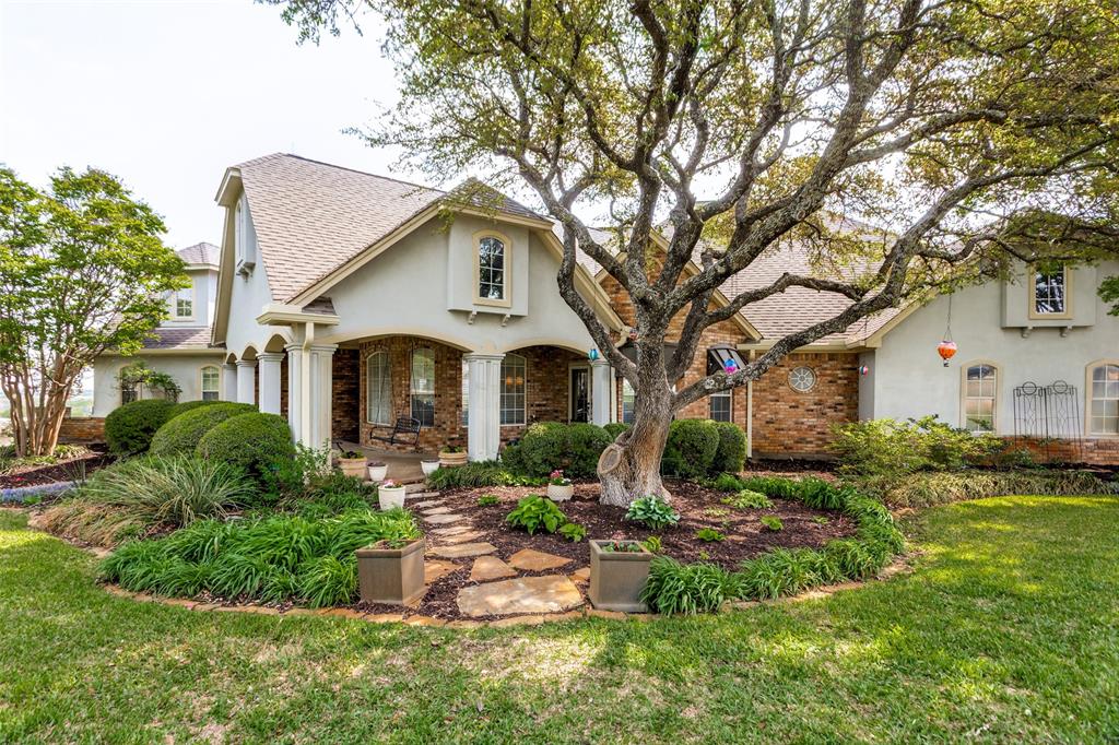 a front view of a house with a yard garage and outdoor seating