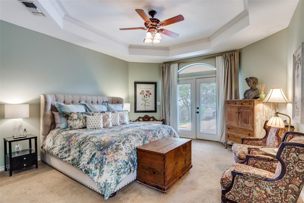 239 Hidden Creek Road Cresson, TX 76035 - Photo 17 of 36 a bedroom with a bed a chandelier and couch