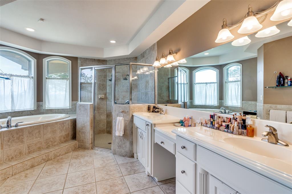 239 Hidden Creek Road Cresson, TX 76035 - Photo 18 of 36 a spacious bathroom with a double vanity sink mirror and bathtub