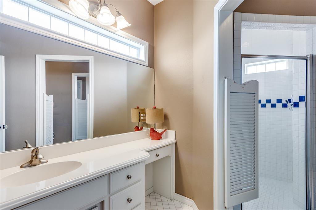 239 Hidden Creek Road Cresson, TX 76035 - Photo 21 of 36 a bathroom with a sink and a mirror