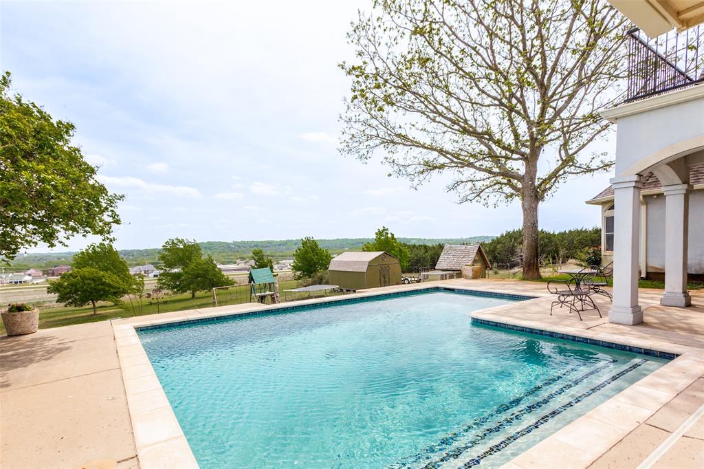 239 Hidden Creek Road Cresson, TX 76035 - Photo 30 of 36 a view of a swimming pool with a patio