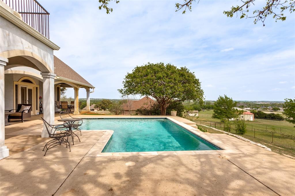 239 Hidden Creek Road Cresson, TX 76035 - Photo 31 of 36 a view of a swimming pool with lounge chair