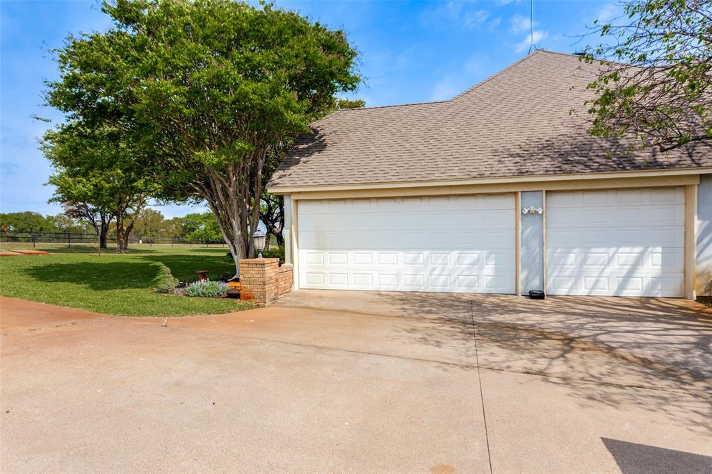 239 Hidden Creek Road Cresson, TX 76035 - Photo 33 of 36 a front view of a house with a yard and garage
