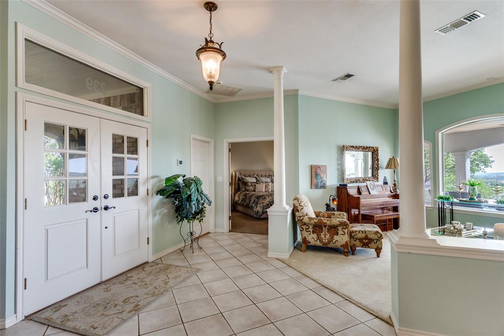 239 Hidden Creek Road Cresson, TX 76035 - Photo 5 of 36 a view of a livingroom with furniture cabinet and a chandelier