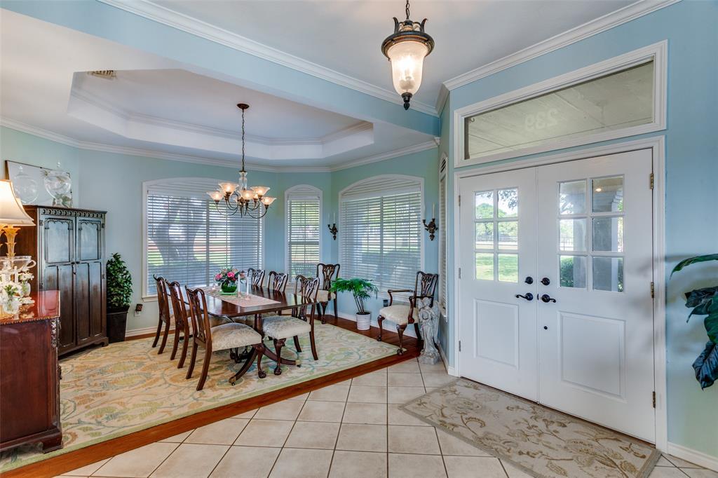 239 Hidden Creek Road Cresson, TX 76035 - Photo 6 of 36 a view of a dining room with furniture wooden floor and chandelier