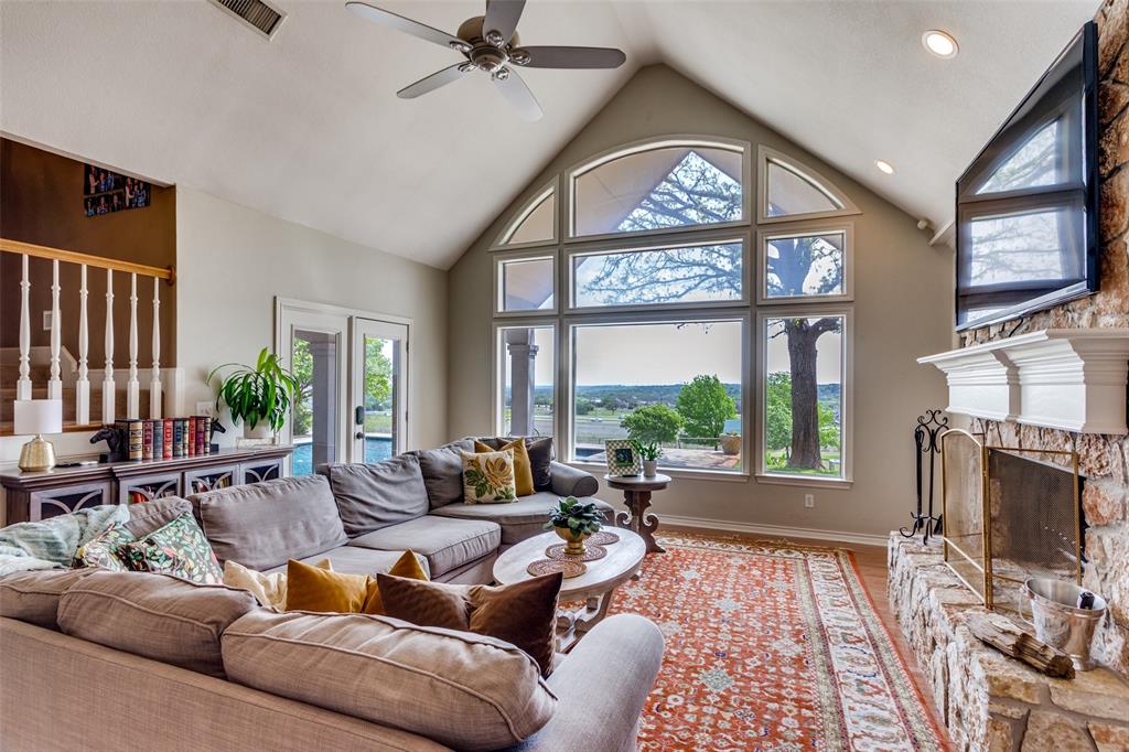 239 Hidden Creek Road Cresson, TX 76035 - Photo 9 of 36 a living room with furniture a flat screen tv and a fireplace