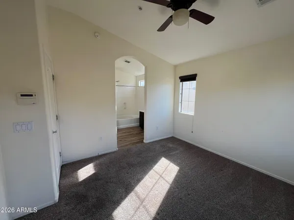 a bathroom with a tub sink vanity granite and shower