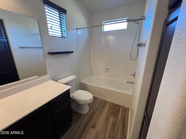 a bathroom with a sink vanity and a mirror