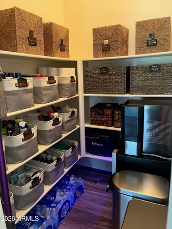 a view of storage and utility room with wooden floor