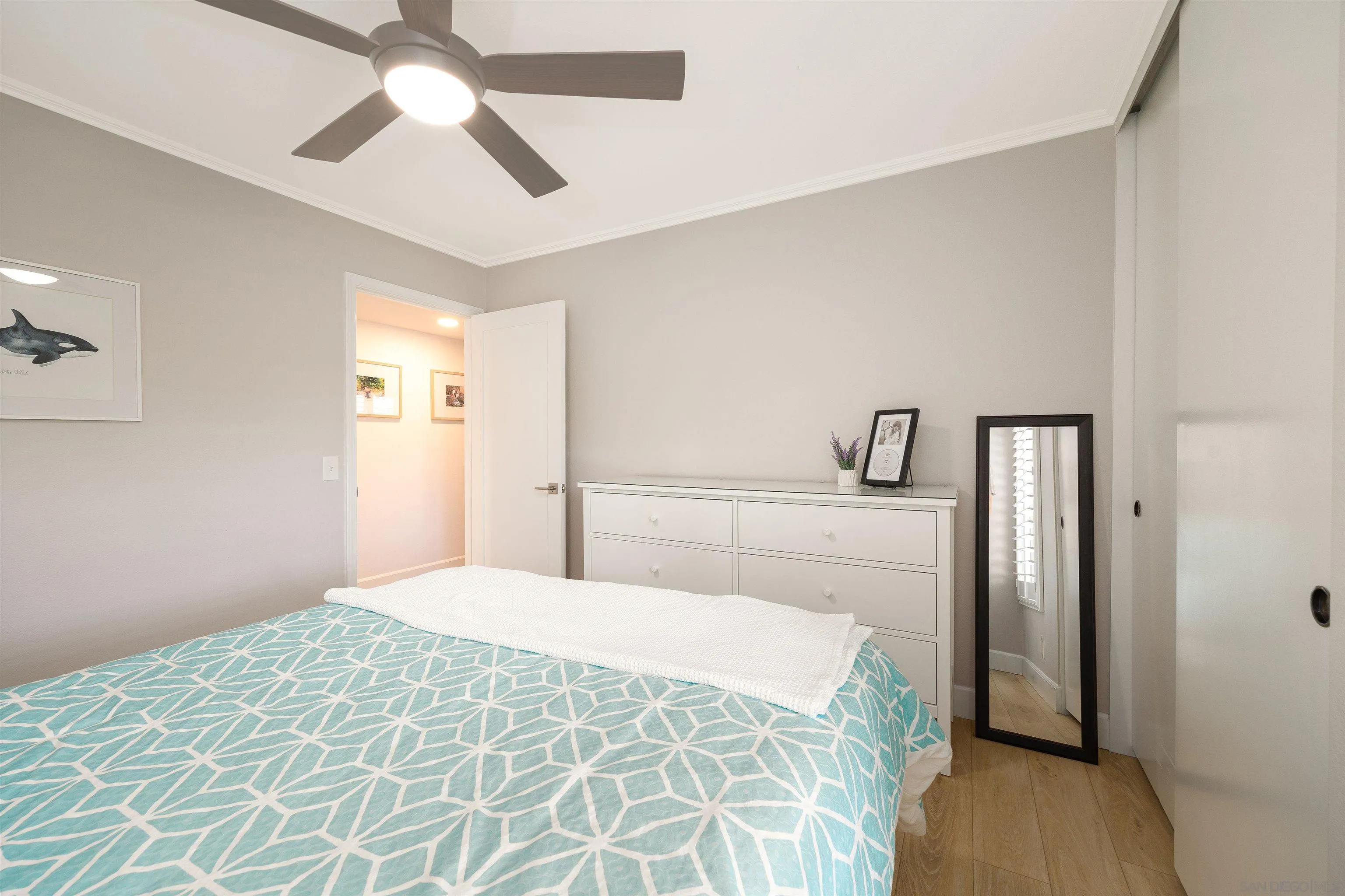 5611 Adobe Falls Road, Unit A San Diego, CA 92120 - Photo 14 of 30 a bedroom with a large bed and a chandelier