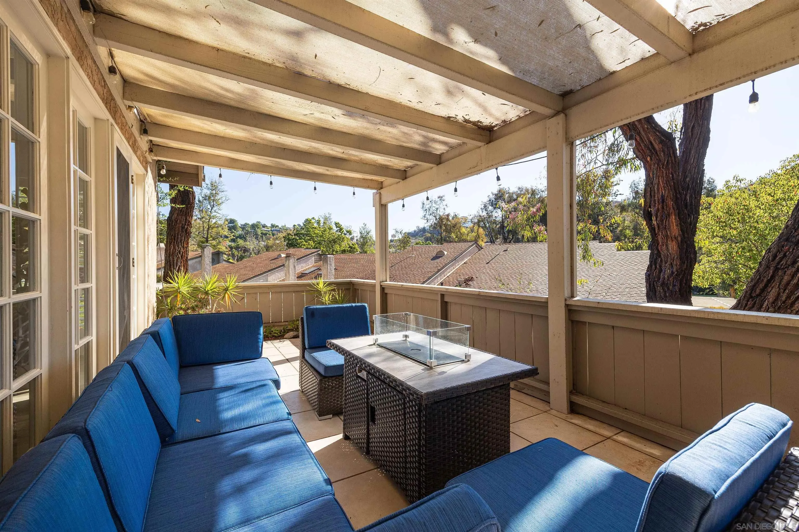 5611 Adobe Falls Road, Unit A San Diego, CA 92120 - Photo 19 of 30 a living room with couch and a floor to ceiling window