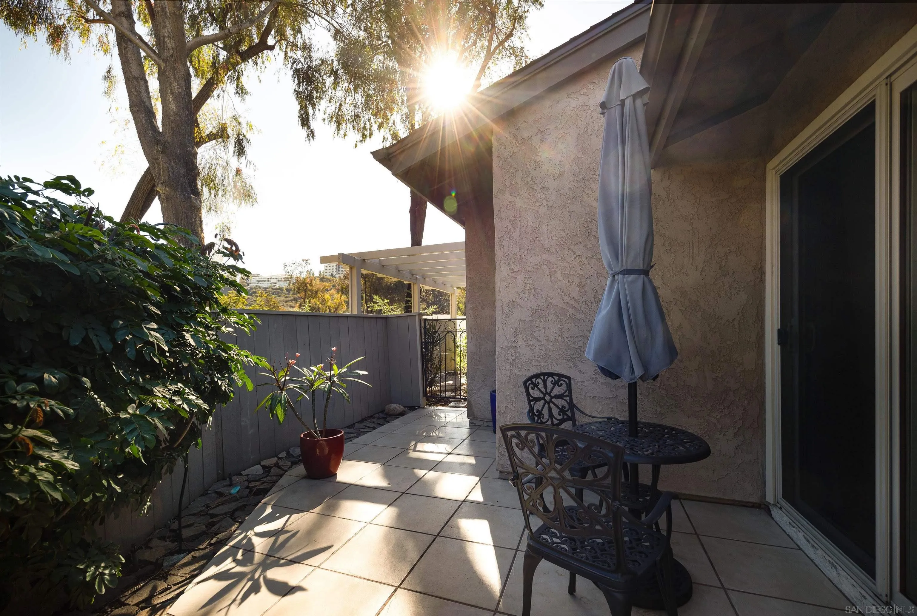 5611 Adobe Falls Road, Unit A San Diego, CA 92120 - Photo 22 of 30 a view of a porch with furniture and a yard