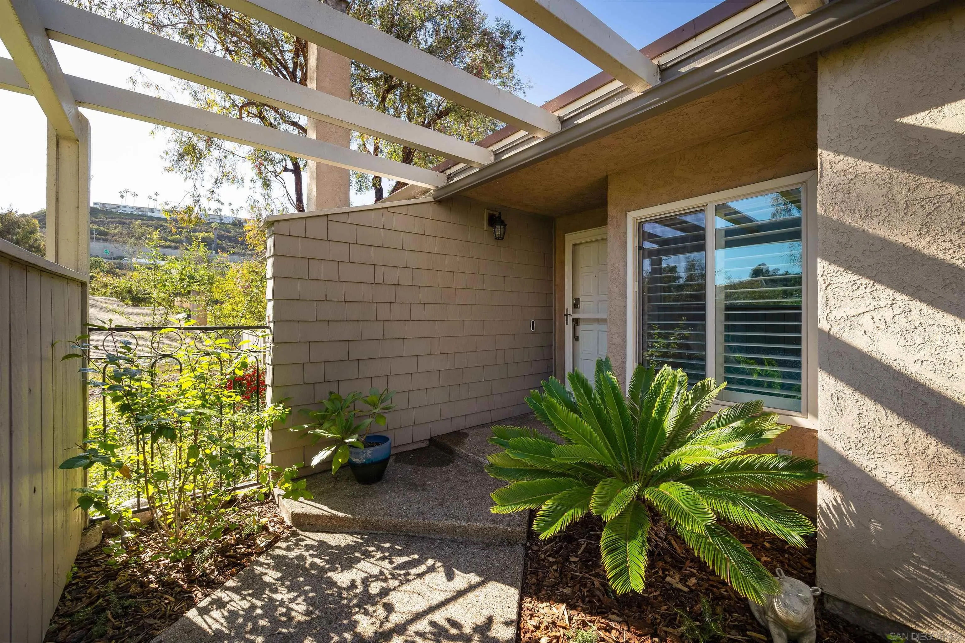 5611 Adobe Falls Road, Unit A San Diego, CA 92120 - Photo 24 of 30 a plant is in front of a door