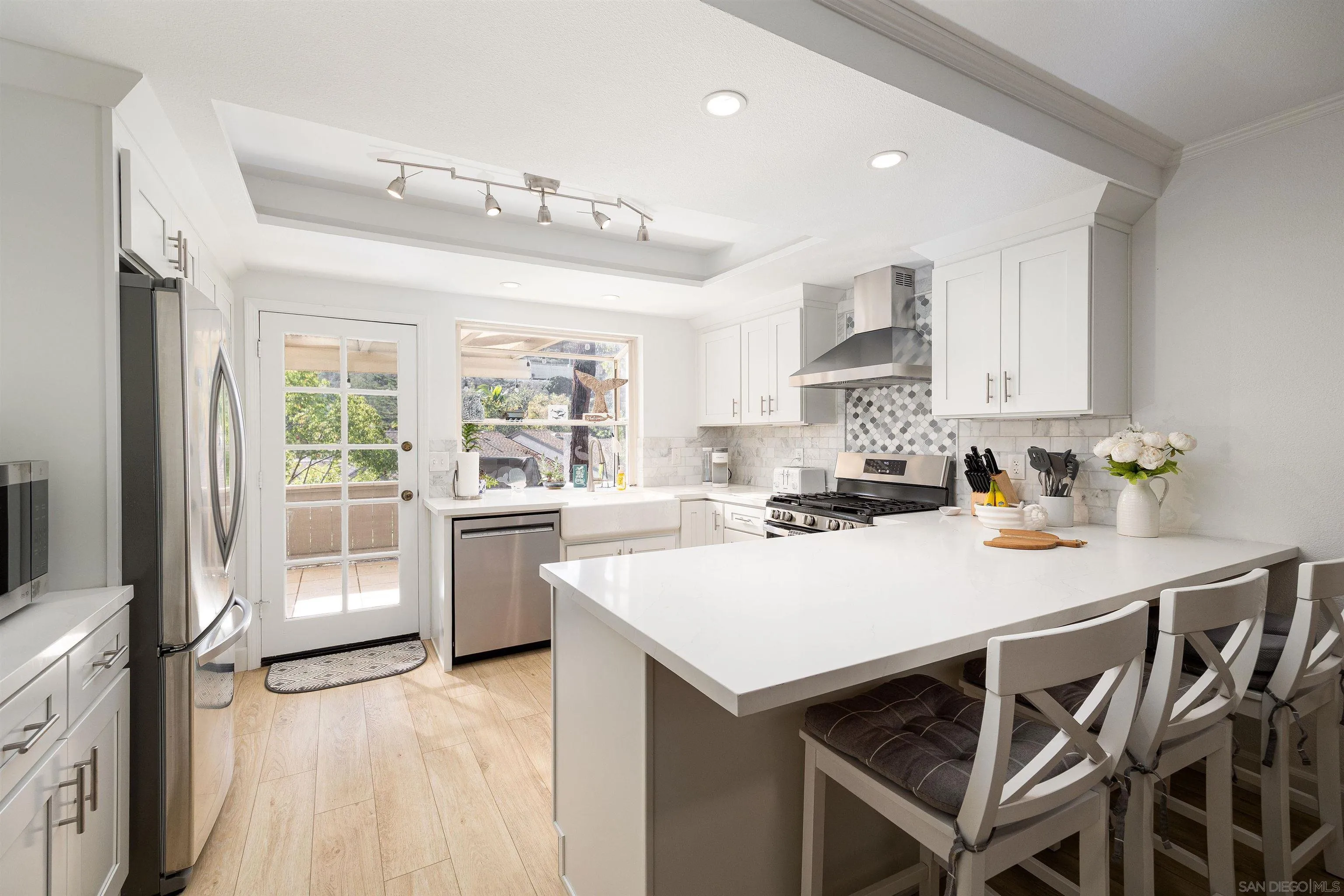 5611 Adobe Falls Road, Unit A San Diego, CA 92120 - Photo 3 of 30 a kitchen with a stove a refrigerator and a stove top oven