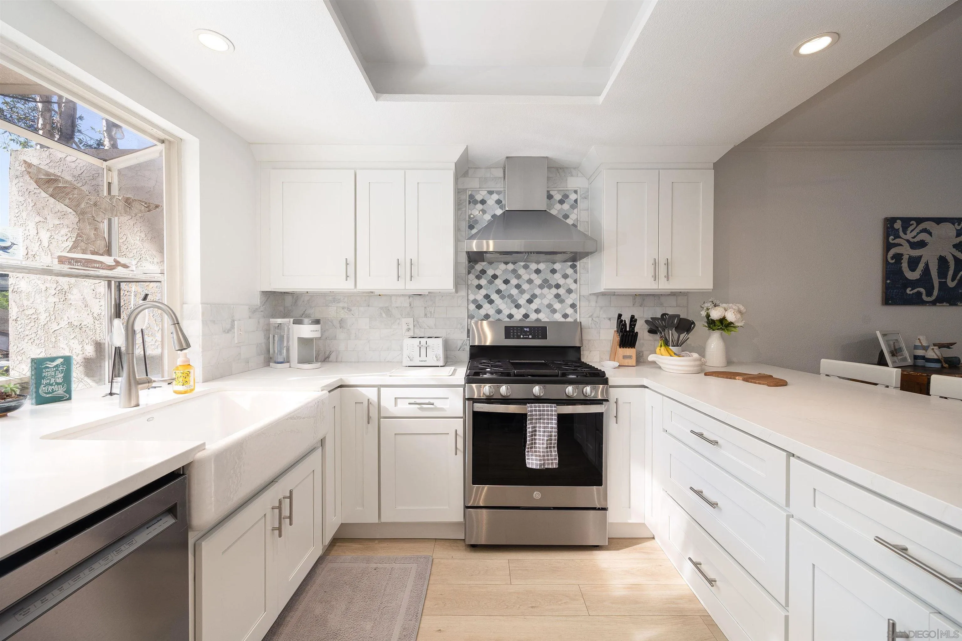 5611 Adobe Falls Road, Unit A San Diego, CA 92120 - Photo 4 of 30 a kitchen with cabinets appliances a sink and a window