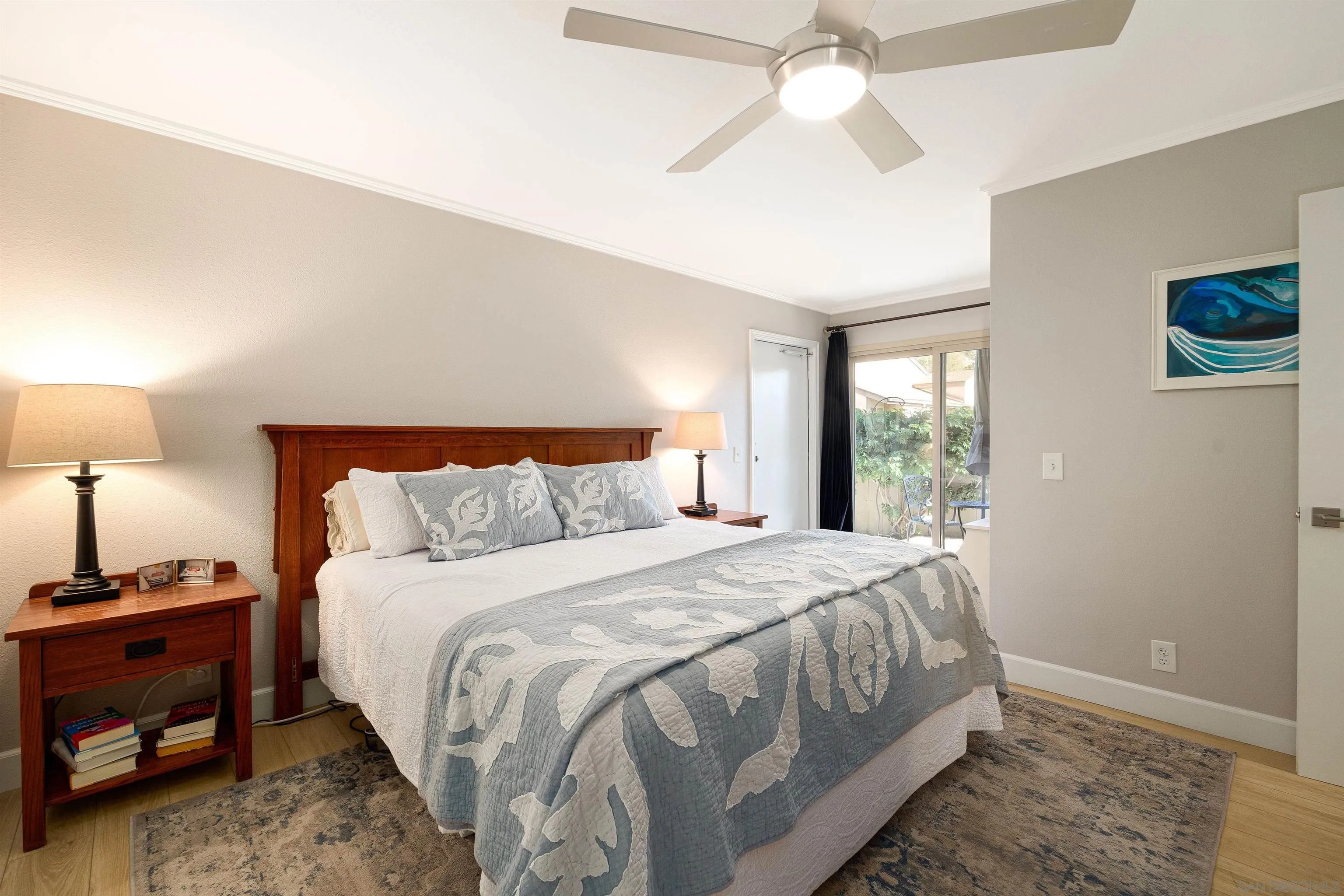 5611 Adobe Falls Road, Unit A San Diego, CA 92120 - Photo 9 of 30 a bedroom with a bed and a lamp