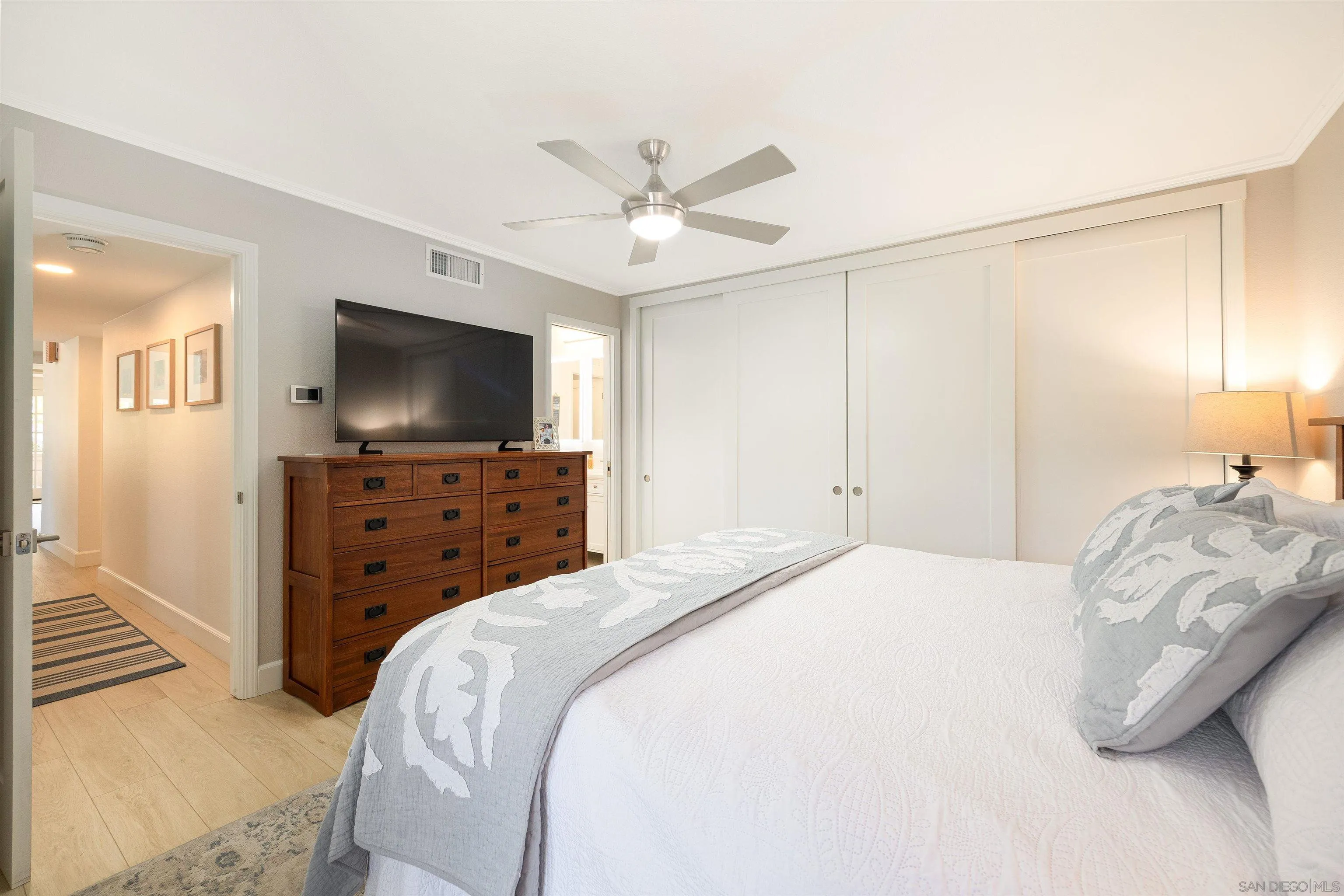 5611 Adobe Falls Road, Unit A San Diego, CA 92120 - Photo 10 of 30 a bedroom with a bed and a flat screen tv