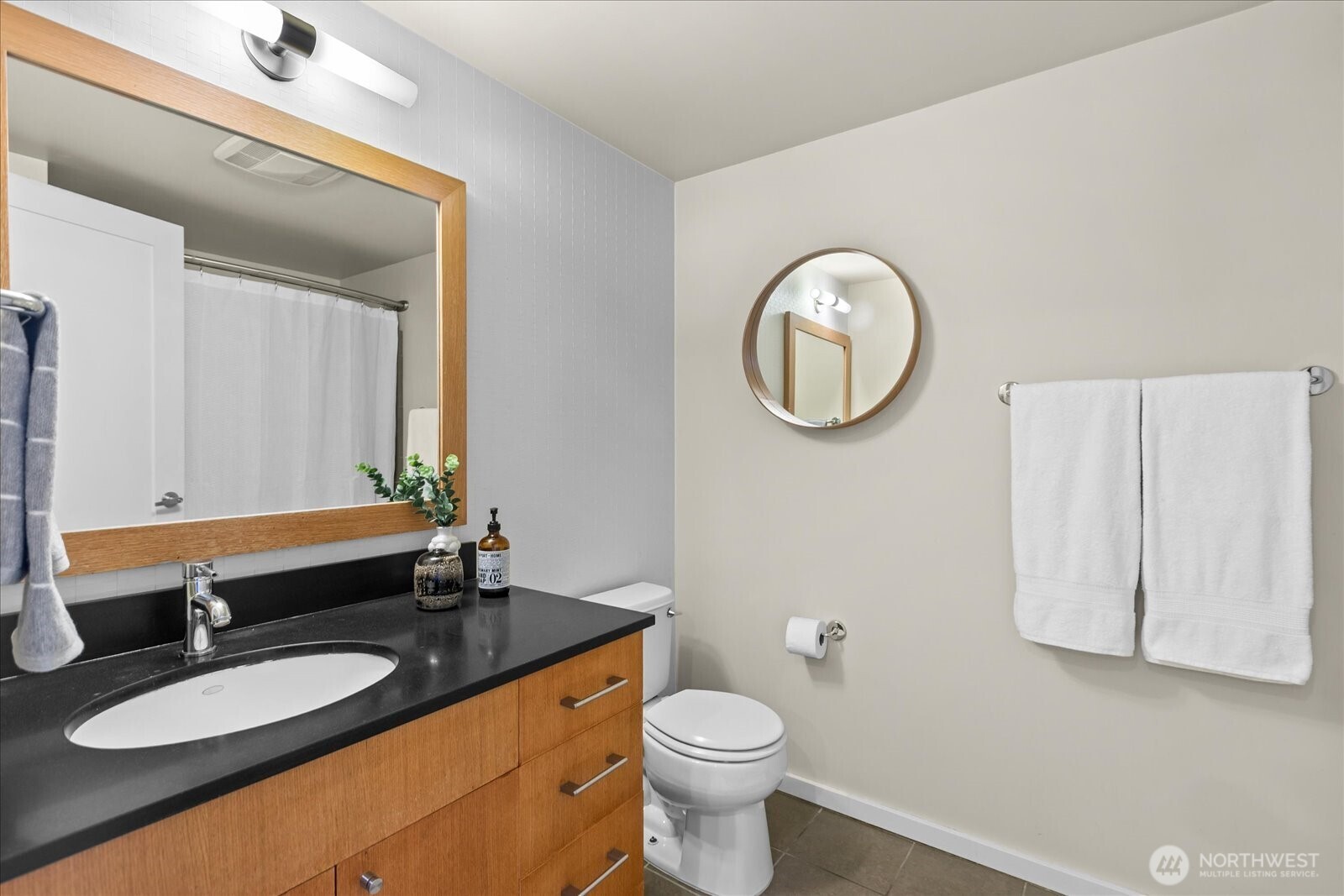76 Cedar Street, Unit PH07 Seattle, WA 98121 - Photo 19 of 33 a bathroom with a granite countertop sink and a mirror