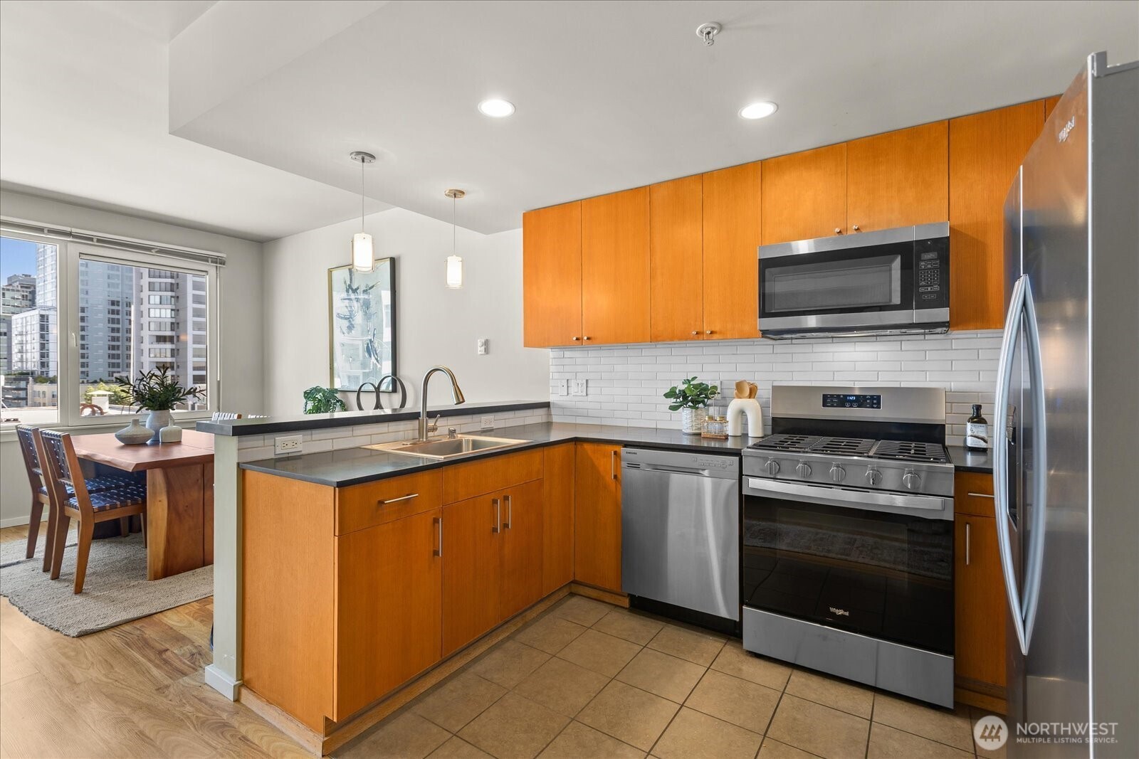 76 Cedar Street, Unit PH07 Seattle, WA 98121 - Photo 9 of 33 a kitchen with stainless steel appliances a stove sink and microwave