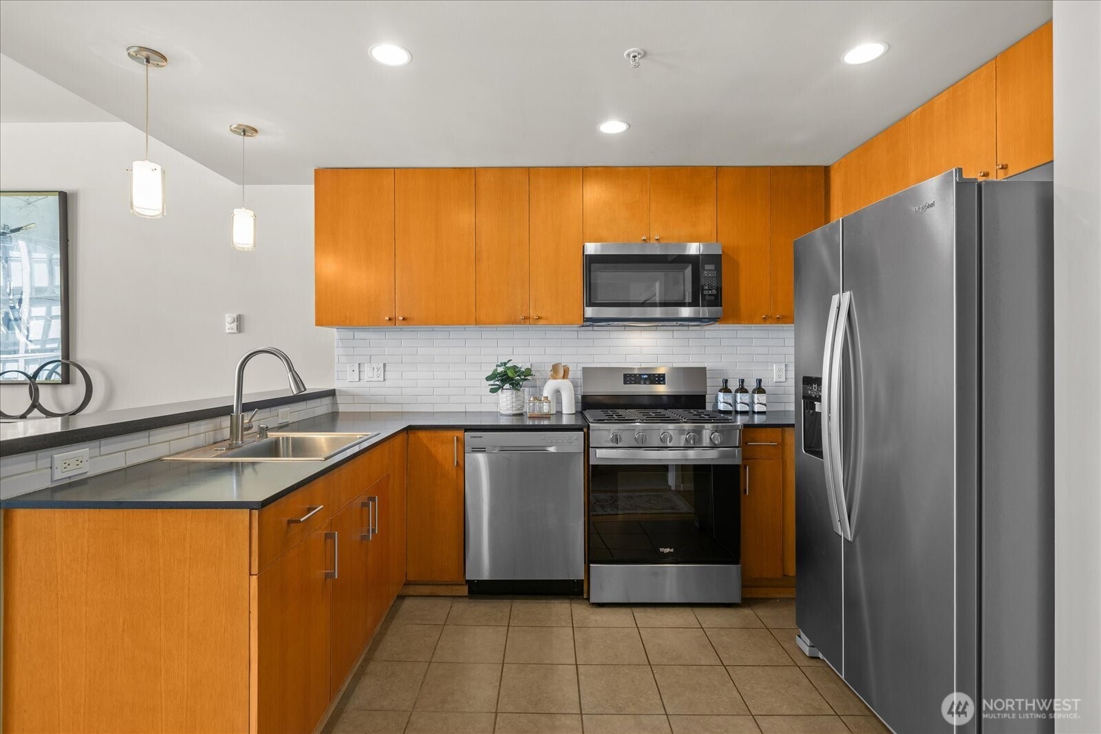 76 Cedar Street, Unit PH07 Seattle, WA 98121 - Photo 10 of 33 a kitchen with stainless steel appliances granite countertop a refrigerator and a sink
