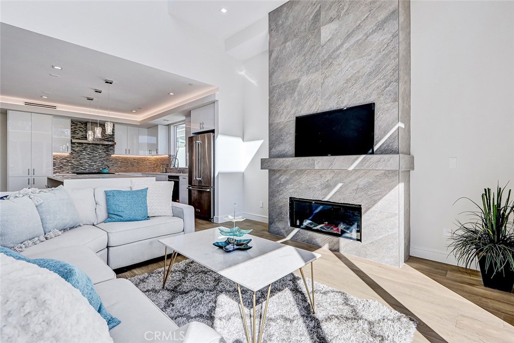 2701 Ruhland Avenue Redondo Beach, CA 90278 - Photo 18 of 38 a living room with furniture a fireplace and a flat screen tv