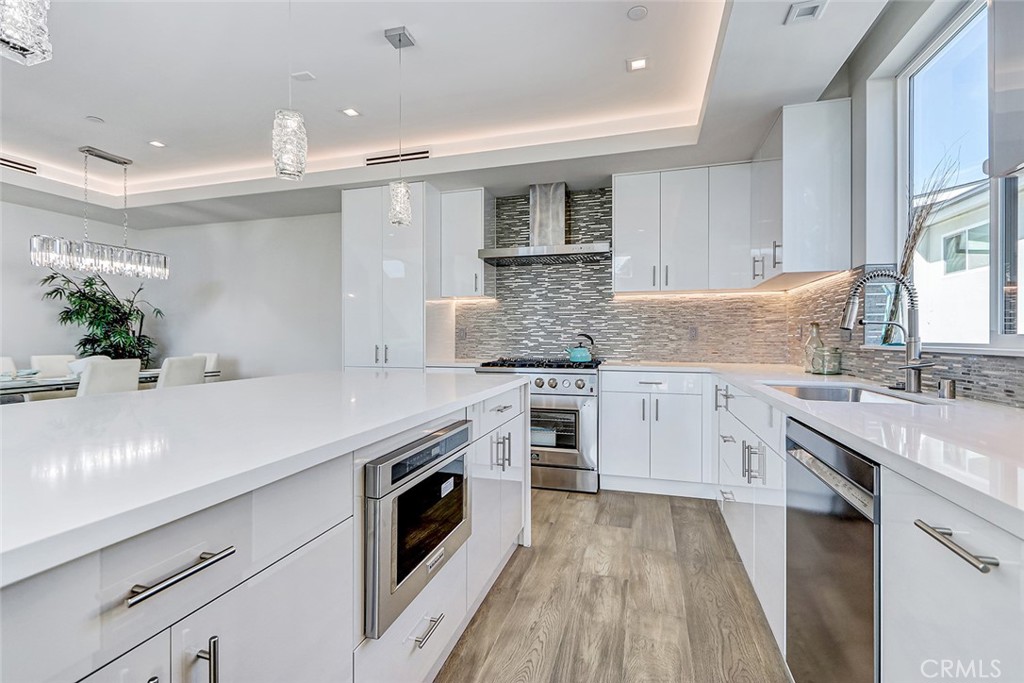 2701 Ruhland Avenue Redondo Beach, CA 90278 - Photo 23 of 38 a kitchen with a sink stove and cabinets