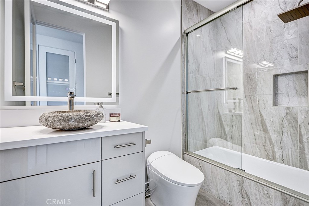 2701 Ruhland Avenue Redondo Beach, CA 90278 - Photo 25 of 38 a bathroom with a granite countertop sink toilet a mirror and shower