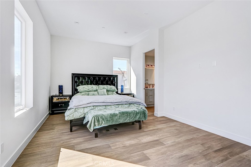 2701 Ruhland Avenue Redondo Beach, CA 90278 - Photo 27 of 38 a bedroom with a bed wooden floor and window