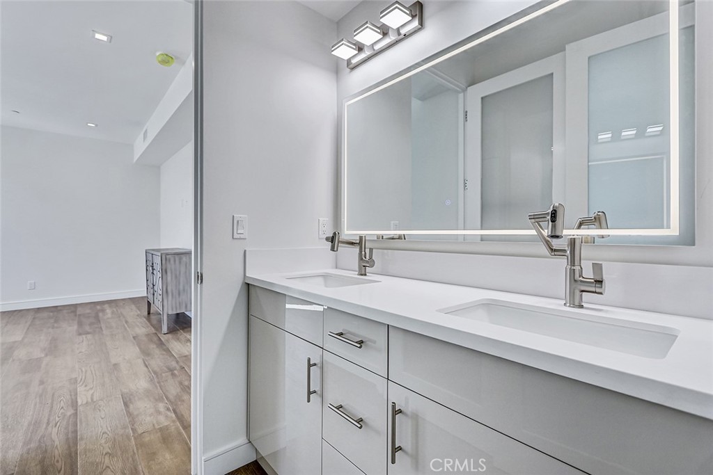 2701 Ruhland Avenue Redondo Beach, CA 90278 - Photo 6 of 38 a bathroom with a double vanity sink and a mirror