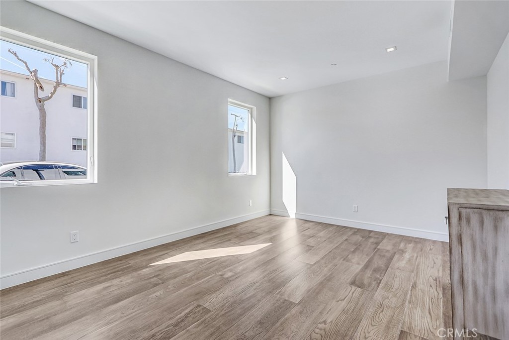 2701 Ruhland Avenue Redondo Beach, CA 90278 - Photo 7 of 38 a view of an empty room with wooden floor and a window