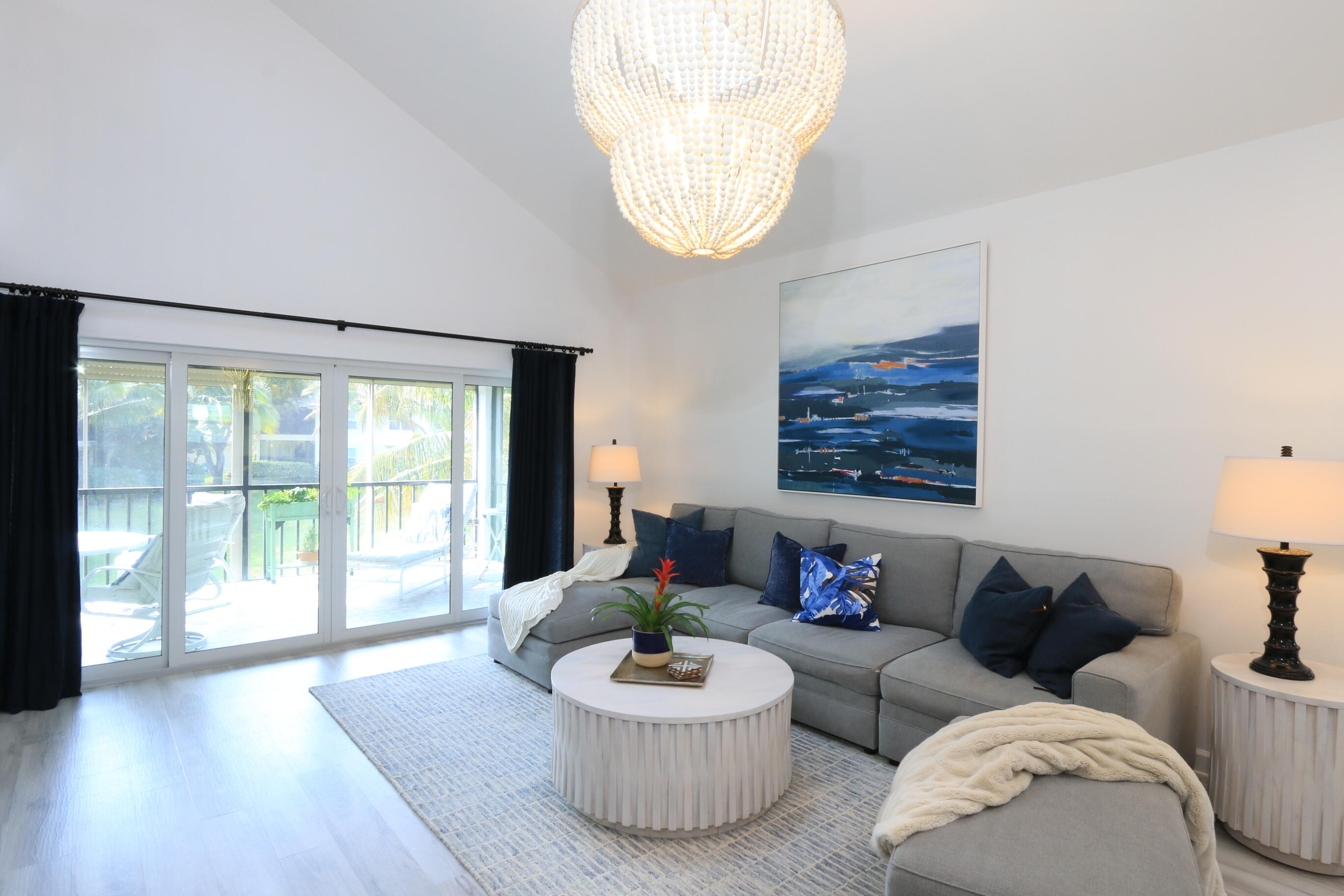 4161 U.S. Highway 1, Unit E3 Jupiter, FL 33477 - Photo 11 of 86 a living room with furniture and a large window