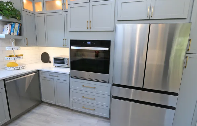 a kitchen with cabinets and stainless steel appliances